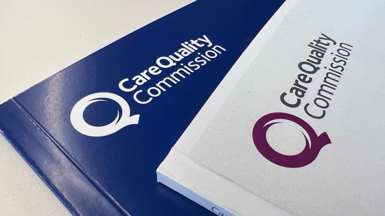 An image of the CQC logo on two stacked booklets