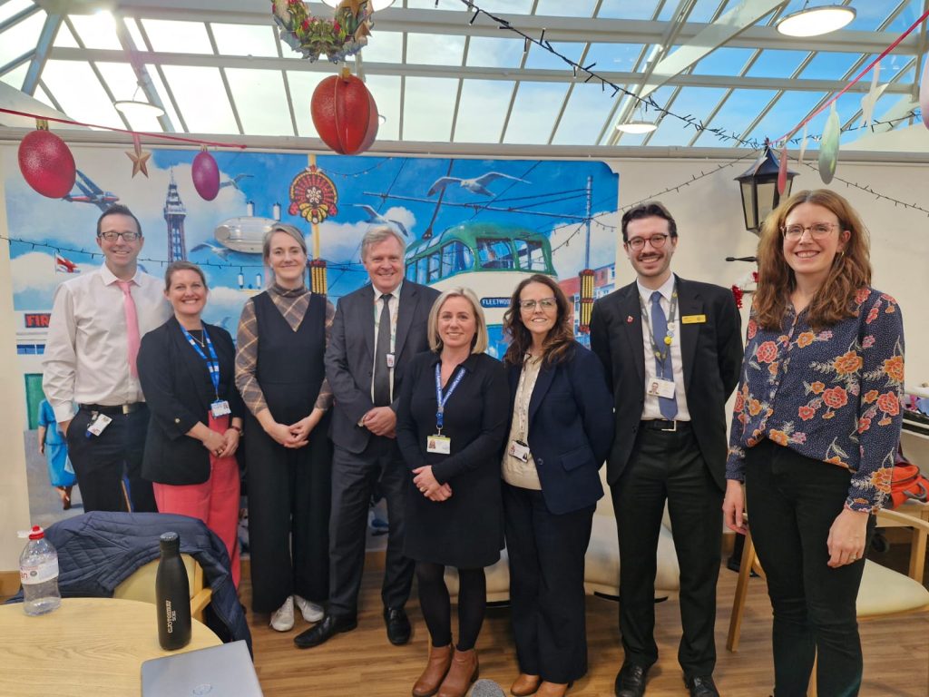 A group of people at the visit pose for a photo