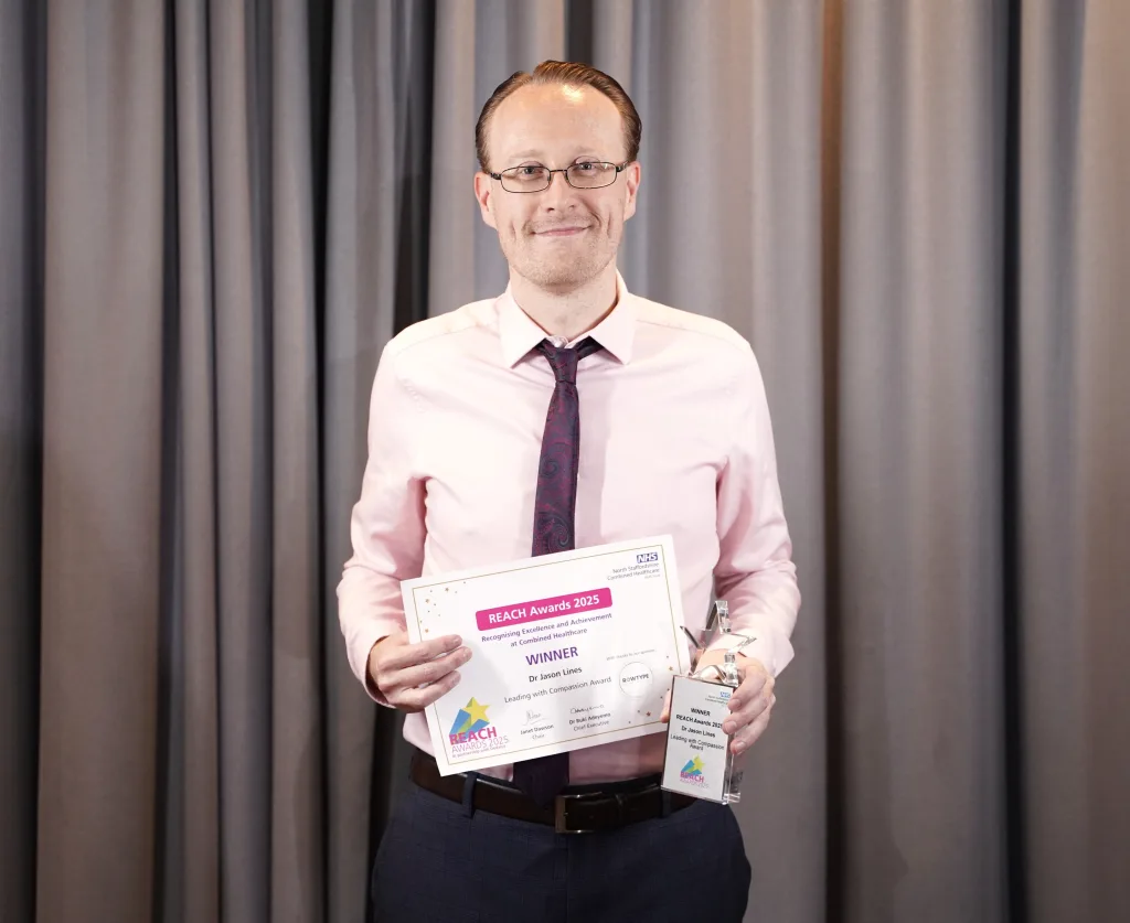 Jason poses with his award