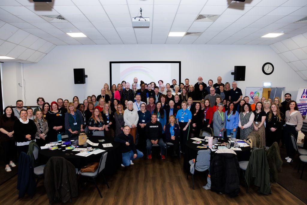 Colleagues at the event pose for a group photo